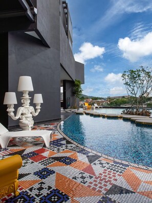 A modern pool area with a geometric tile design, a white outdoor lamp, and a view of the surrounding landscape. - CozyStay 3BR at Arte Cheras 4-Min Walk to MRT & Close to TRX/KLCC/Bukit Bintang (Kuala Lumpur)