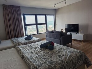 A hotel room with two beds, a sofa, a TV, and a window with curtains. - CozyStay 3BR at Arte Cheras 4-Min Walk to MRT & Close to TRX/KLCC/Bukit Bintang (Kuala Lumpur)