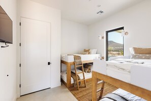 A modern bedroom with a bunk bed, a desk, and a television mounted on the wall. - NEW Modern Sanctuary | Minutes to Zion Desert | Pool, Spa and Game Room (Virgin)
