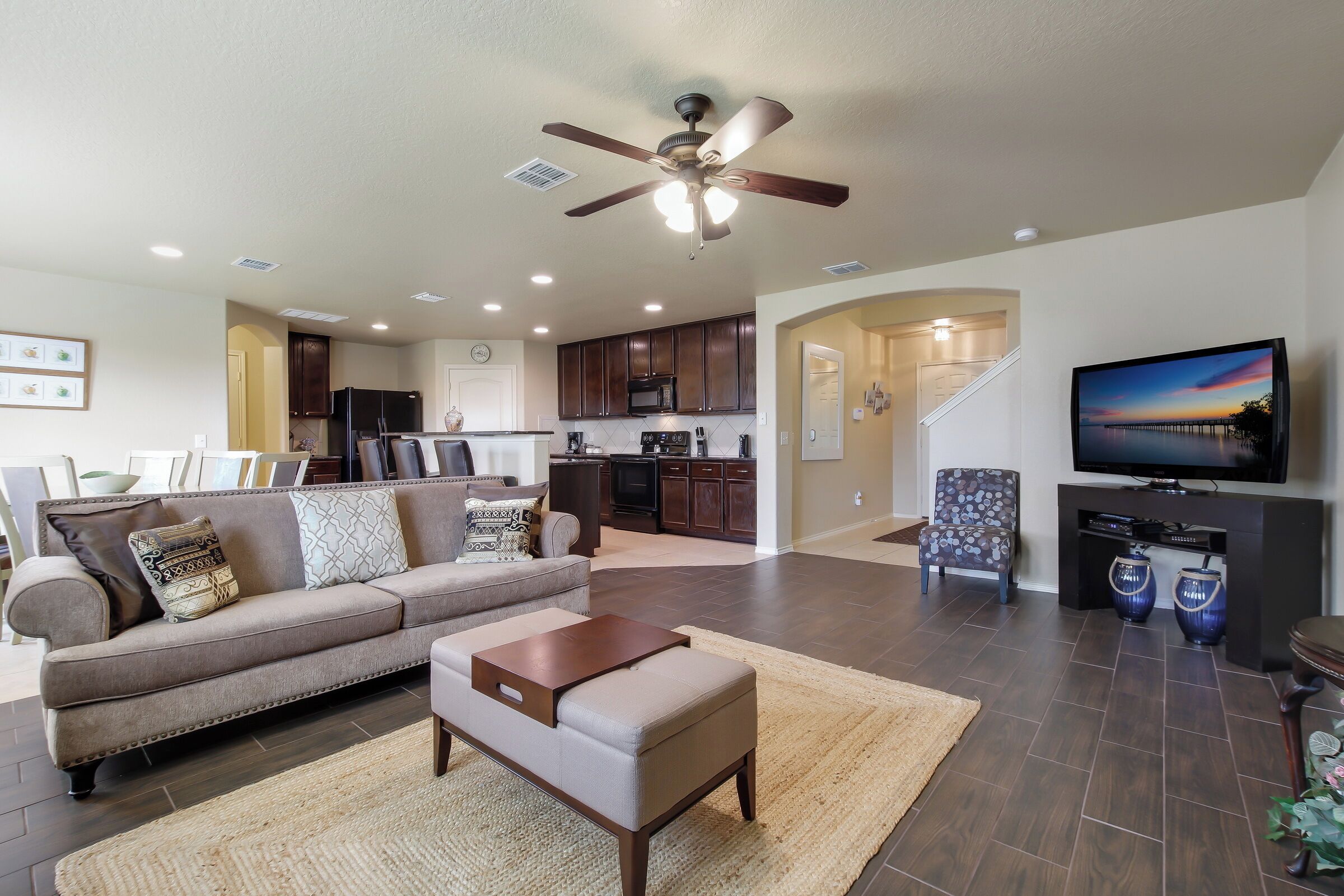 A modern living room with a sofa, coffee table, and a television.