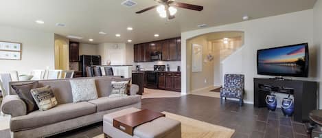 A modern living room with a sofa, coffee table, and a television.