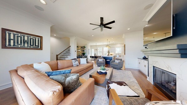 A modern living room with a sofa, coffee table, and fireplace.