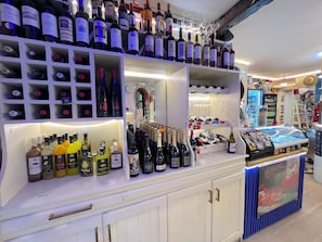 A wine and liquor display with various bottles and glasses.