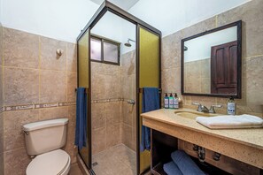 A bathroom with a toilet, sink, mirror, shower, and towels. - Playas del Coco Condo w/ Pool: Near Beach! (Playas del Coco)