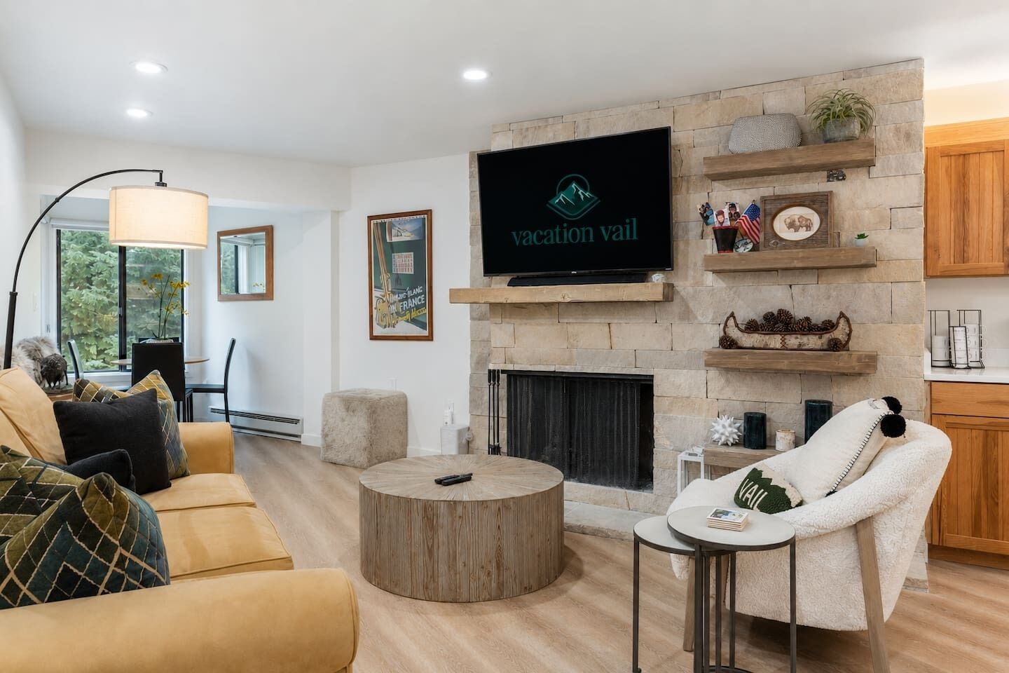 A modern living room with a fireplace, a flat-screen TV, and a cozy seating area.