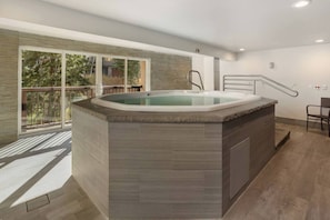 A modern bathroom with a freestanding bathtub, a shower area, and a glass-enclosed balcony. - Fallridge Condo - Steps to Nordic Center and Bus (Vail)