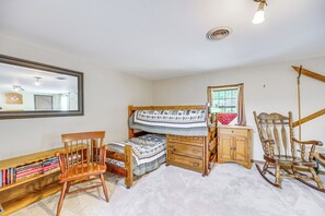 A room with a bunk bed, a wooden desk with books, a rocking chair, and a window with curtains. - Walk to Echo Lake State Park! Family Escape (Conway)