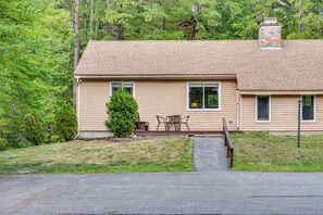 A single-story house with a brick chimney, a small front porch with a table and chairs, and a well-maintained lawn. - Walk to Echo Lake State Park! Family Escape (Conway)