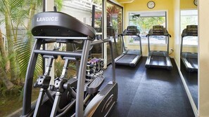 A gym with a Landice elliptical machine, treadmills, and dumbbells. - Princeville North Shore Escape - The Cliffs Club 1BR Suite, Ocean Area (Princeville)