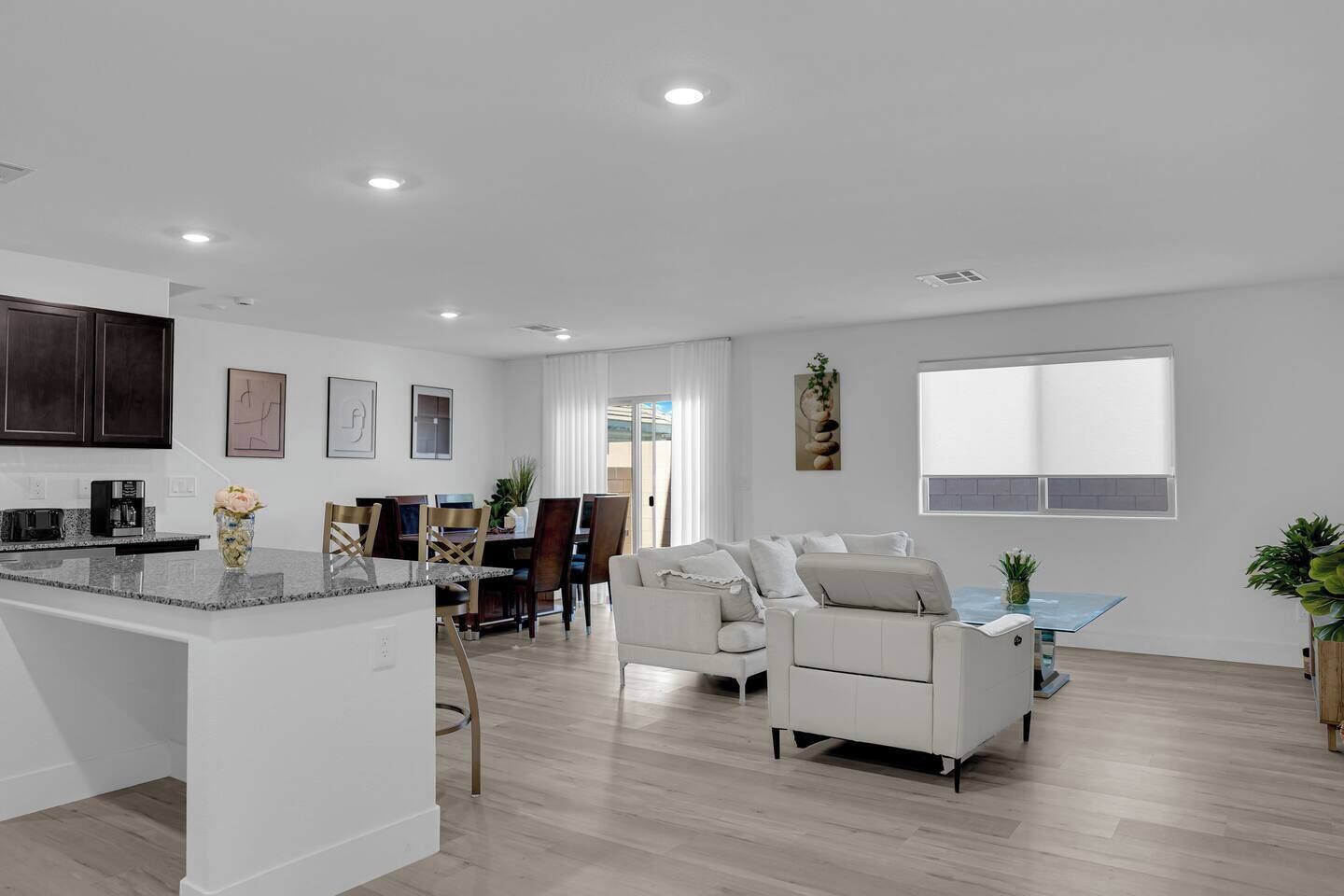 A modern living space with a kitchen, dining area, and seating area.
