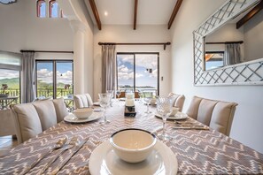 A dining area with a table set for four, large windows, and a view of the outdoors. - Ocean-View Retreat! Playa Penca Resort Condo (Playa Penca)