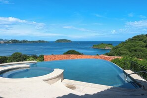 A swimming pool with a view of the sea and distant islands. - Ocean-View Retreat! Playa Penca Resort Condo (Playa Penca)