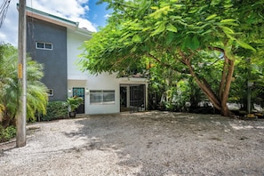 A modern two-story building with a gravel driveway and a large tree in the foreground. - Playa Carrillo: Private Pool, 1 Mi to Beach (Playa Carrillo)