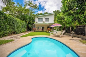 A swimming pool with a patio area, surrounded by lush greenery and a two-story house. - Playa Carrillo: Private Pool, 1 Mi to Beach (Playa Carrillo)