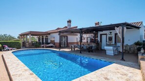 A swimming pool with a sun terrace, outdoor seating, and a foosball table. - Villa La Guirnalda Alhaurín el Grande by Ruralidays (Málaga)