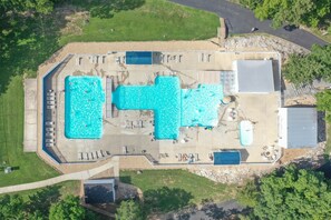 An aerial view of a property with two swimming pools, a covered patio area, and a parking lot. - Bigfoot’s Bunk: Cozy Cabin on Table Rock Lake (Kimberling City)