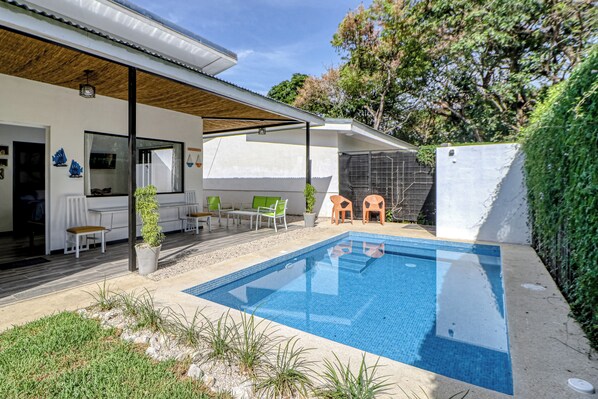 A modern outdoor pool area with a covered seating area and a patio. - Pool & Entertaining Patio: Playa Carrillo Home (Playa Carrillo)