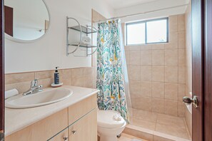 A bathroom with a sink, toilet, and shower area. - 3 Mi to Beach: Modern Santa Cruz 2BR Condo (Tamarindo)