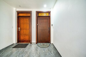 Two wooden doors with a sign above the right door. - Oceanfront Escape in Playa Potrero, Costa Rica (Playa Potrero)