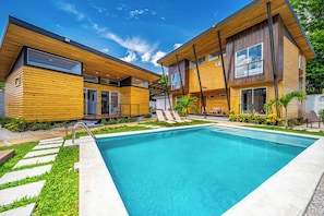 A modern two-story house with a swimming pool, wooden exterior, and a well-maintained garden. - 2 Studios w/ Pool Access < 1 Mi to Playas Del Coco (Playas del Coco)