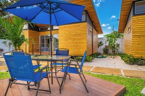 A patio with a table and chairs, an umbrella, and a wooden deck. - 2 Studios w/ Pool Access < 1 Mi to Playas Del Coco (Playas del Coco)