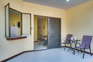 A room with a sliding door leading to a dining area with a table and chairs. - Family Retreat w/ Pool Access: Walk to Beach! (Playas del Coco)