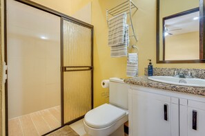 A bathroom with a toilet, sink, and a shower area. - Family Retreat w/ Pool Access: Walk to Beach! (Playas del Coco)