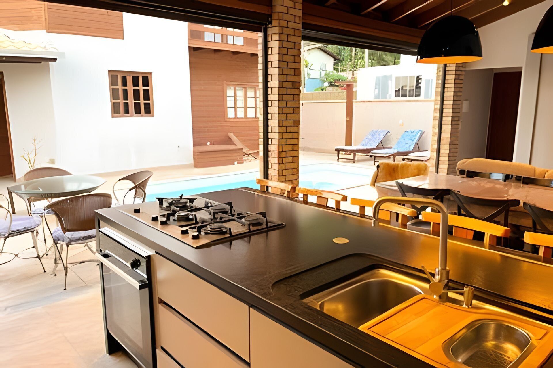 A modern kitchen with a central island, a built-in dishwasher, and a large sink.
