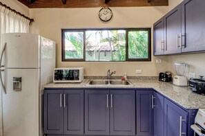 A kitchen with a refrigerator, microwave, sink, and cabinets. - Beach Access & Resort Perks: Playa Hermana Villa (Playa Hermosa)