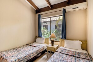 A room with two single beds, a small table with a lamp, and a window with curtains. - Beach Access & Resort Perks: Playa Hermana Villa (Playa Hermosa)