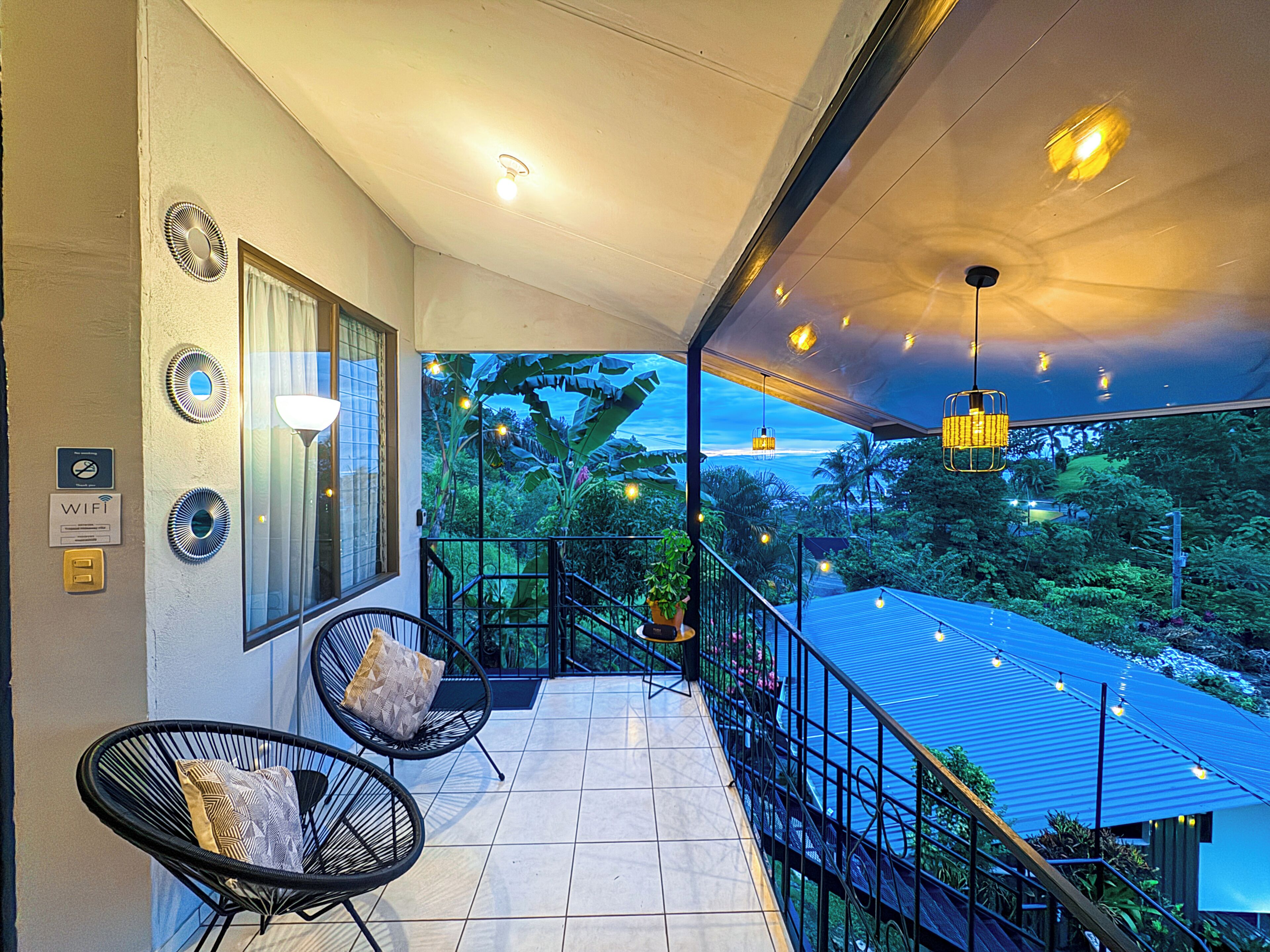 Un balcon avec vue sur l’océan, une chaise et une rambarde.