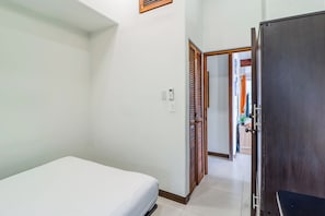A hotel room with a bed, a wardrobe, a door leading to another room, and a thermostat on the wall. - Villa Sol Resort Gem w/ Soaking Pool & Views! (Playa Hermosa)