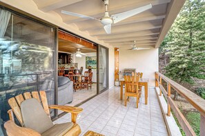 A spacious patio with a dining area, a seating area with a sofa, and a view of the outdoors. - Ideal 2BR Oceanfront 2nd-Floor | Balcony (Flamingo Beach)