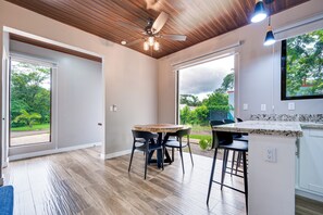 A modern kitchen with a wooden ceiling, large windows, and a dining area with bar stools. - 5 Mi to Beach: Updated Playa Avellanas Gem (Playa Avellanas)