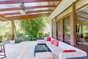 A covered outdoor seating area with a sofa, cushions, and a table. - Bahia Pez Vela Resort: Condo w/ Beach Access! (Playa Ocotal)