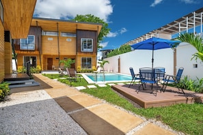 A modern two-story house with a swimming pool, outdoor seating, and a well-maintained garden. - Private 2-Studio Retreat Near Playa Del Coco! (Playas del Coco)