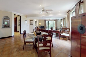 A spacious dining area with a round table, chairs, and a ceiling fan. - Playa Conchal Resort Condo w/ Ocean View (Playa Conchal)