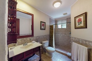 A bathroom with a vanity, toilet, shower, and a large mirror. - Playa Conchal Resort Condo w/ Ocean View (Playa Conchal)