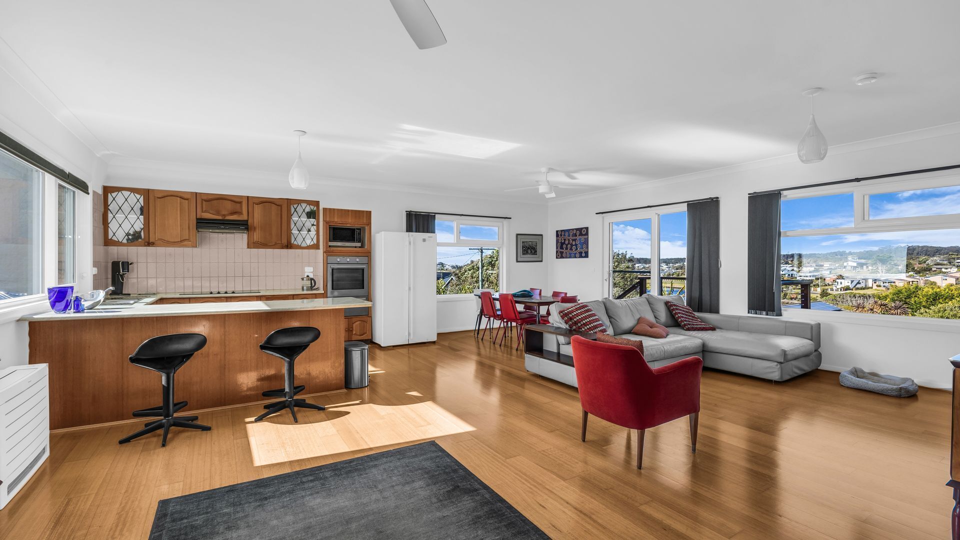 A modern apartment with a kitchen, dining area, and living room.