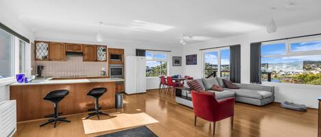 A modern apartment with a kitchen, dining area, and living room.