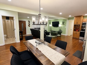A modern kitchen with wooden cabinets, a built-in oven, and a microwave. - The KC Garden Retreat- 10 Mins to Everything! (Kansas City)