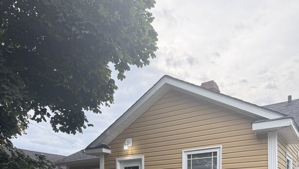 A single-story house with a front porch, a mailbox, and a number '39' sign. - Grand Falls-Windsor Gem | King Bed + Movie Room (Grand Falls-Windsor)