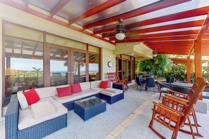 A spacious living area with a large sectional sofa, a coffee table, and a dining table with chairs. - 2-Unit Bundle: Bahia Pez Vela Resort Villas (Playa Ocotal)