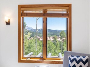 A room with a large window offering a view of a mountainous landscape. - Crystal Ridge | Stunning Views, Private Hot Tub, & Walk to Gondola/Village Core (Mountain Village)