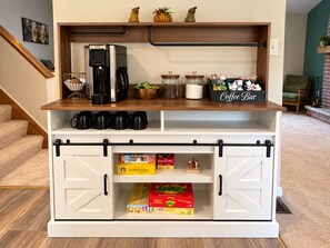 A coffee station with a coffee maker, mugs, and a coffee bar sign. - TNT Pocono Haven - 5BR - Sleeps 14 - Minutes from Kalahari (Pocono Summit)