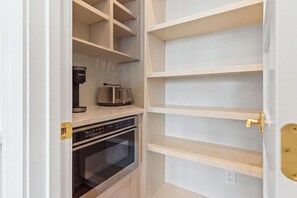 A kitchen with a built-in oven, a coffee maker, and a toaster. - This Must Be The Place (Ocean Isle Beach)