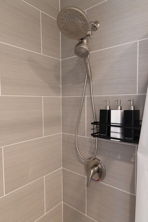 A shower with a handheld showerhead and a wall-mounted control valve. - Cozy 2-bedroom house in tranquil Clovis with AC (Clovis)