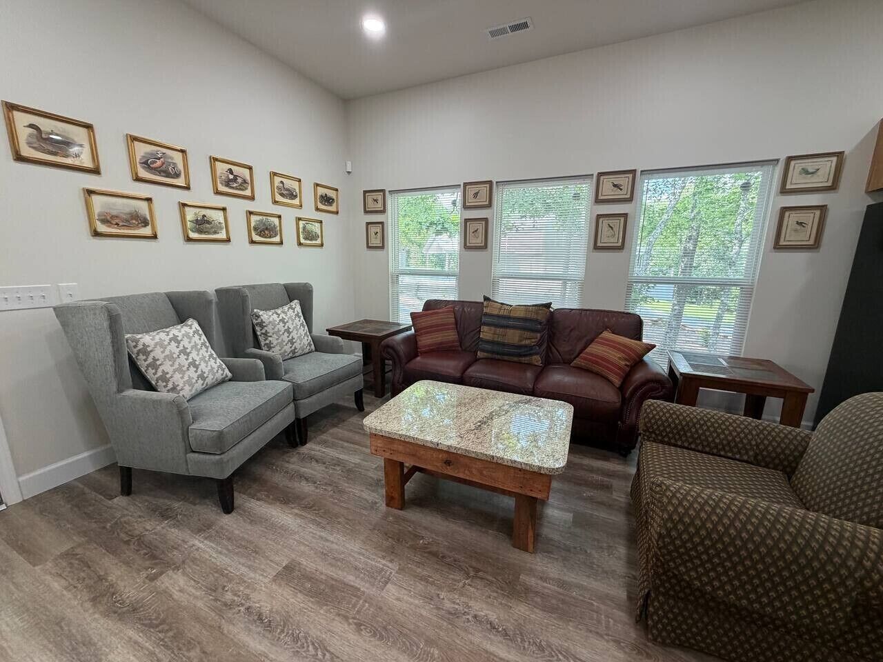 A living room with two sofas, a coffee table, and framed pictures on the wall.