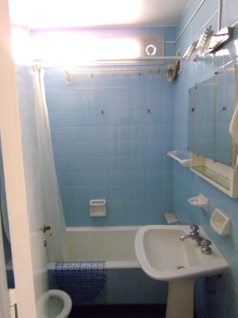 A bathroom with a bathtub, a sink, and a toilet.