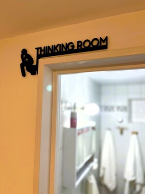 A sign above a door labeled 'THINKING ROOM' with a silhouette of a person sitting on a chair. - Jungle Chic in Palermo · Vibrant & Unique (Buenos Aires)